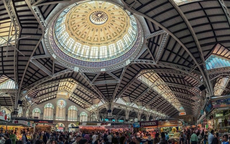 VALENCIA, SPAIN - OCTOBER 10, 2015: View of crowded Central Market interiors. It is considered one of the oldest European markets still running, most vendors sell food items. Beautiful design